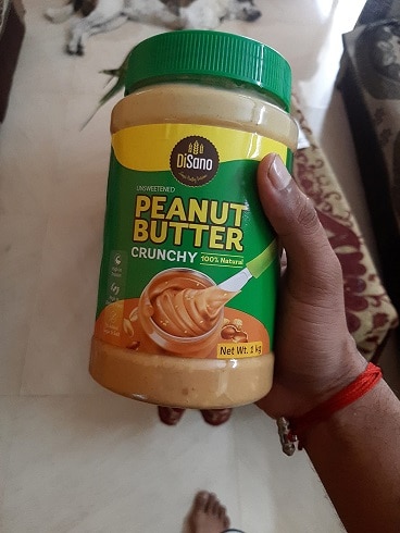 Me Holding a Container of DiSano Peanut Butter