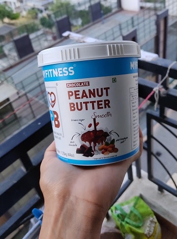 Me Holding a Container of MYFITNESS Chocolate Peanut Butter