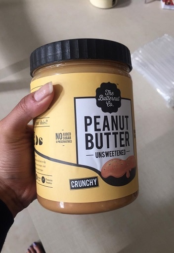 Me Holding A Container of The Butternut Co Natural Peanut Butter